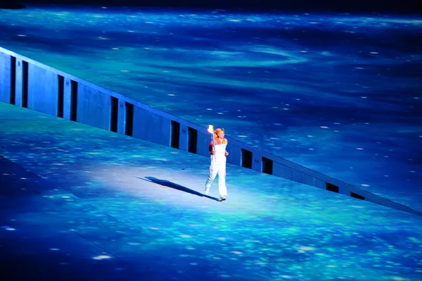 Russian tennis player Maria Sharapova with the Olympic flame.