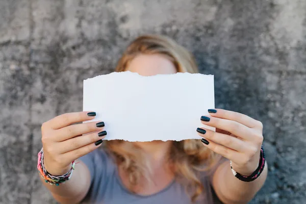 Teenage girl holding sheet of paper