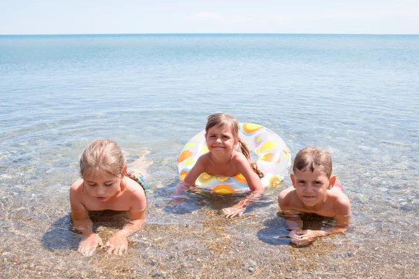 Three children in the sea