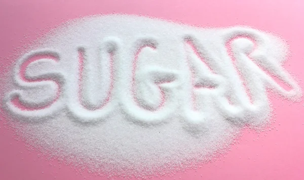 Sugar written in granulated sugar pile