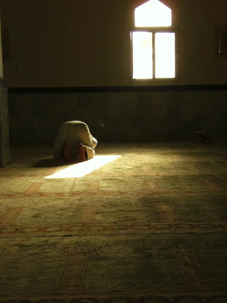 A muslim prostrate during prayer in one of the mosques in Saudi Arabia