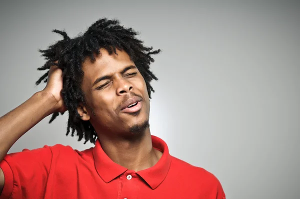 Young Man Twists His Hair While Plotting