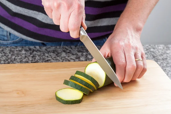 Man cutting a zucchini