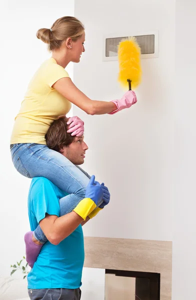 Man helping his wife in cleaning