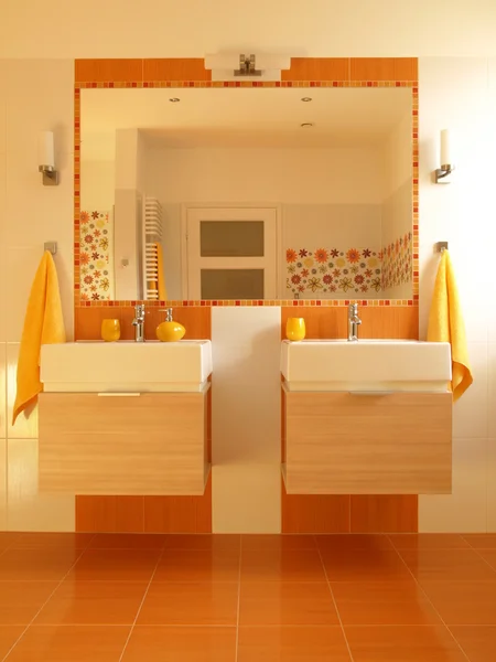 Orange bathroom with double sink