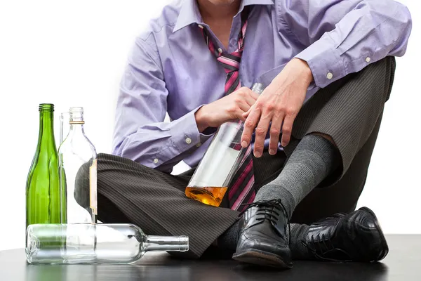 Depressed businessman drinking alcohol