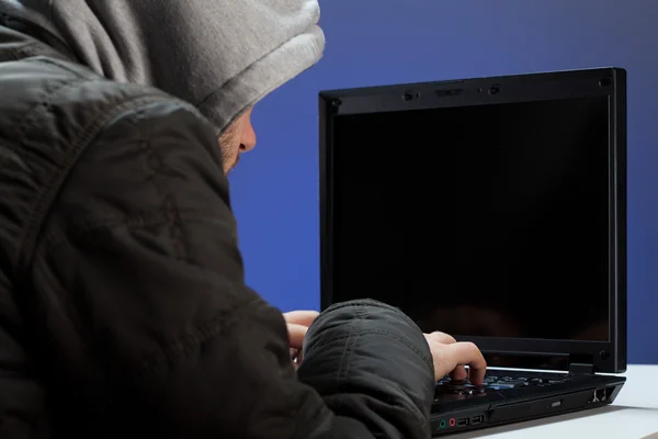 Hacker writing on laptop