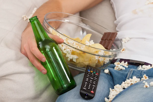 Junk food, bottle and remote