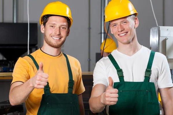 Production workers showing thumbs up sign