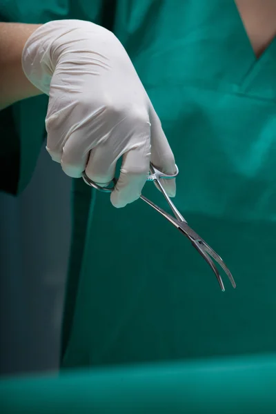 Close-up of a surgeon\'s hand with surgical scissors