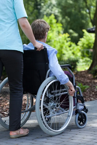 The nurse with disabled woman