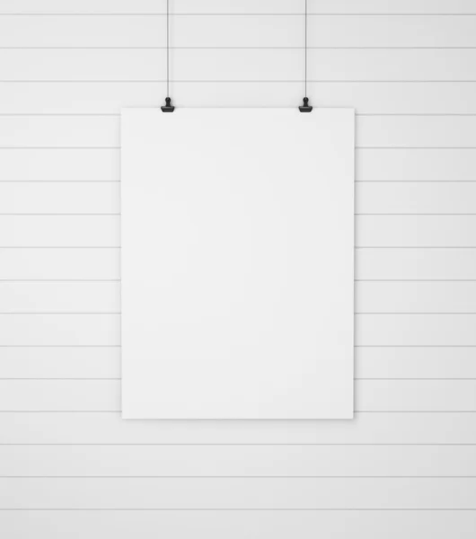 Blank paper with clips on wood background