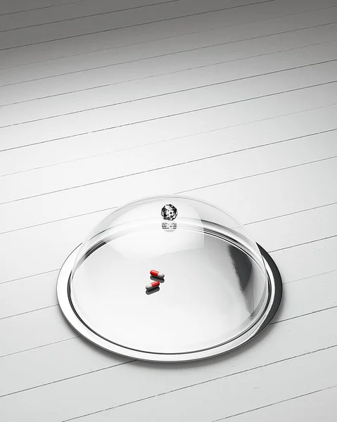 Pills in Glossy salver dish with an cover over it on a white wooden background