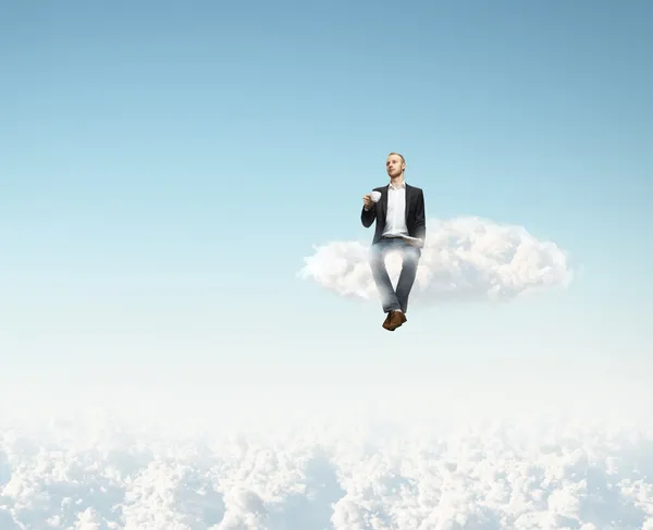 Man on a cloud with cup of coffee