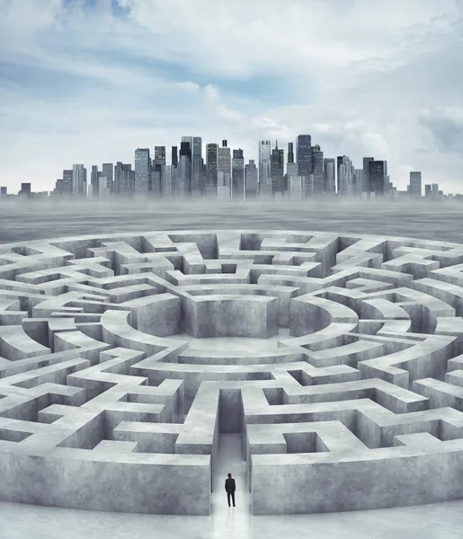 Businessman in maze and city on horizon
