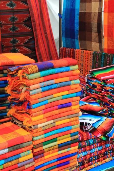 Colorful fabric for sale at a Mexican craft market