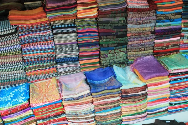 Colorful silk and woven fabric for sale in a Cambodian market