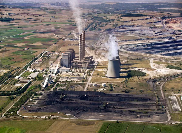 Fossil fuel power plant & coal piles, aerial view