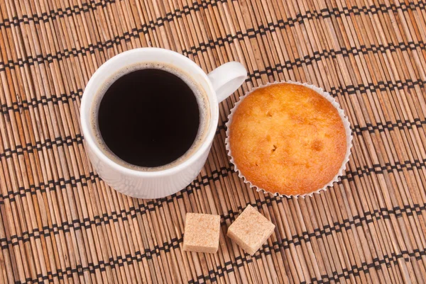 Espresso coffee in a white china cup over wood surface