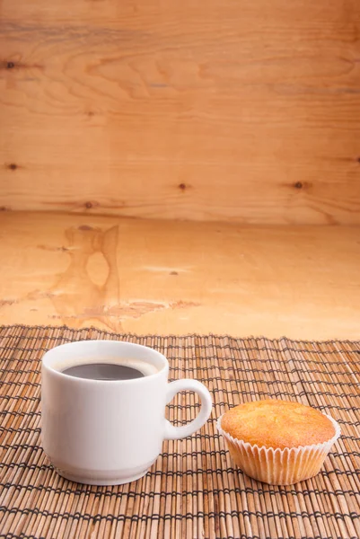 Espresso coffee in a white china cup over wood surface