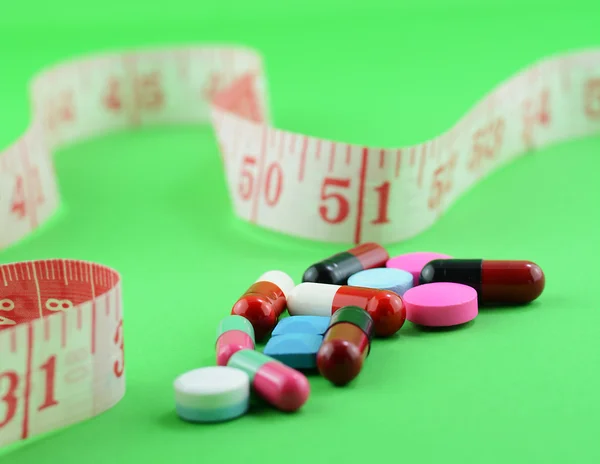 Measuring tape and pills for dieting