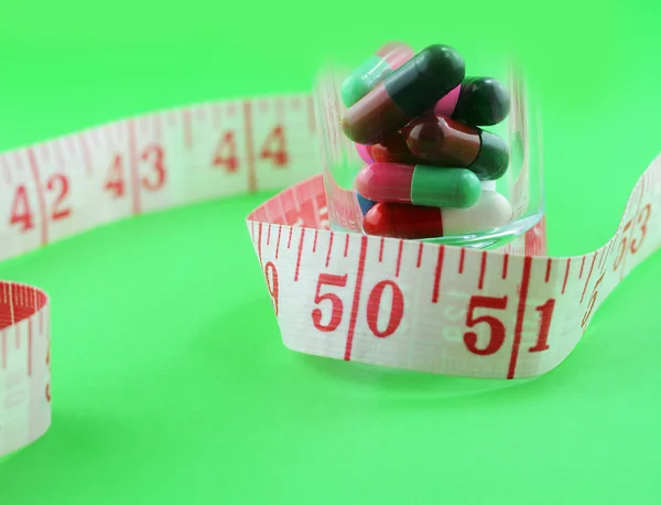 Measuring tape and pills for dieting
