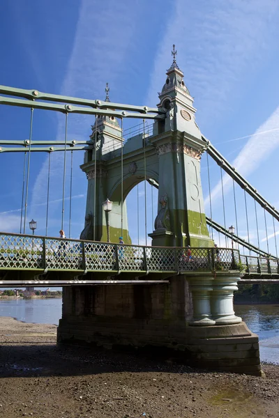 Hammersmith Bridge is a suspension bridge which crosses the River Thames in West London