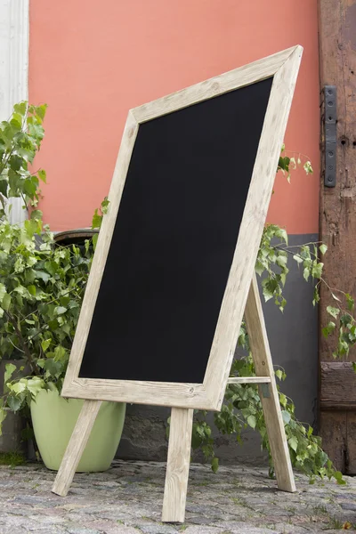Empty black board (menu board) at a restaurant