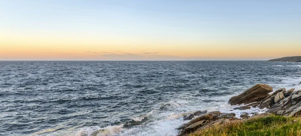 Panorama of an ocean shore at the crack of dawn