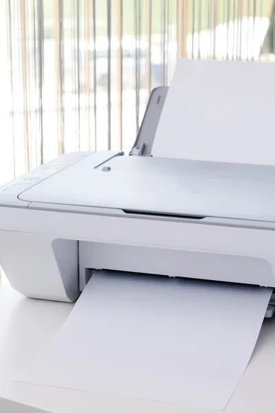 White printer on the desk in office.