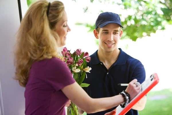 Delivery: Woman Signs for Flowers