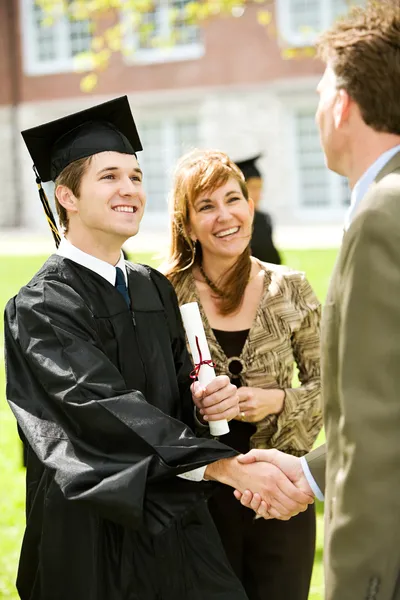 Graduation: Teacher Congratulates New Graduate