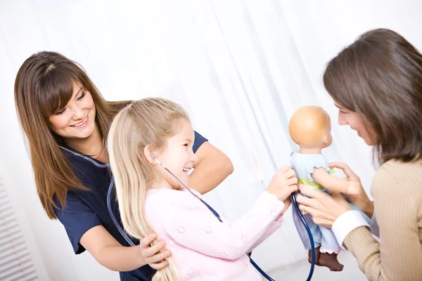 Nurse: Girl Checks Doll While Nurse Checks Girl