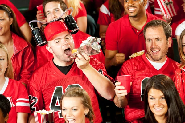 Fans: Male Fan Eats Hot Dog With Beer Helmet On