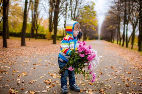 Little boy with a bouquet of flowers