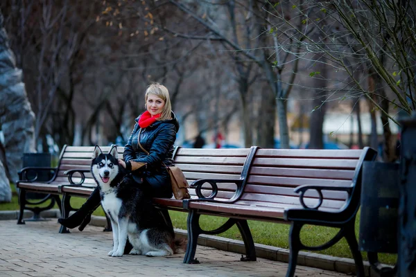 Woman sitting on bench with dog