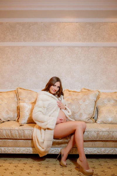 Pregnant woman in fur coat