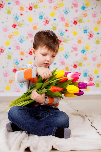 Beautiful boy with tulips