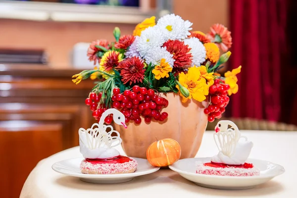 Chrysanthemums and cakes in the shape of swans