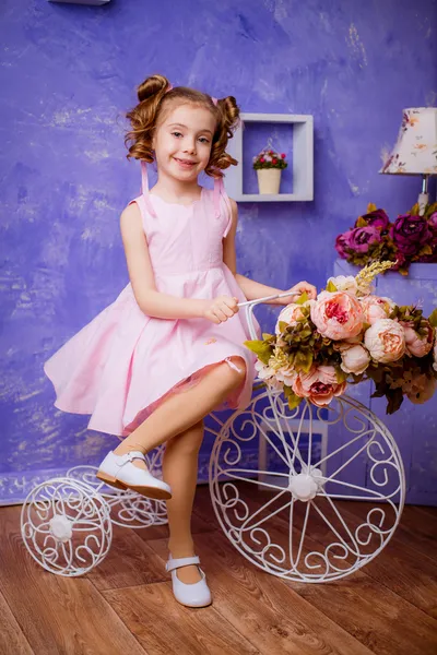 Little  girl  with flowers in the room