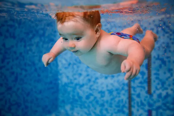 Baby diving in the swimming pool.