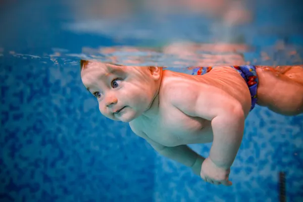 Baby diving in the swimming pool.