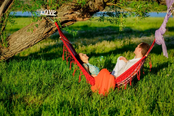 Couple relaxing in a hammock