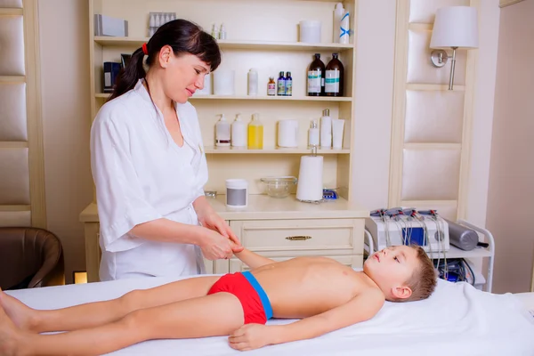 Doctor massaging little boy