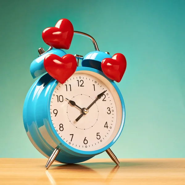 Alarm clock with three hearts over