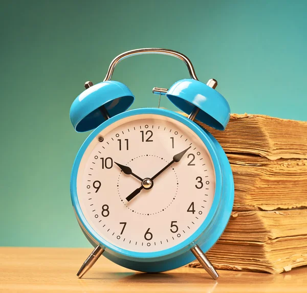 Alarm clock and old books