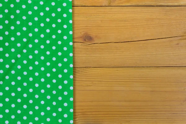 Empty wooden deck table with tablecloth with polka dots