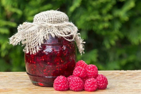 Glass jar of raspberry jam