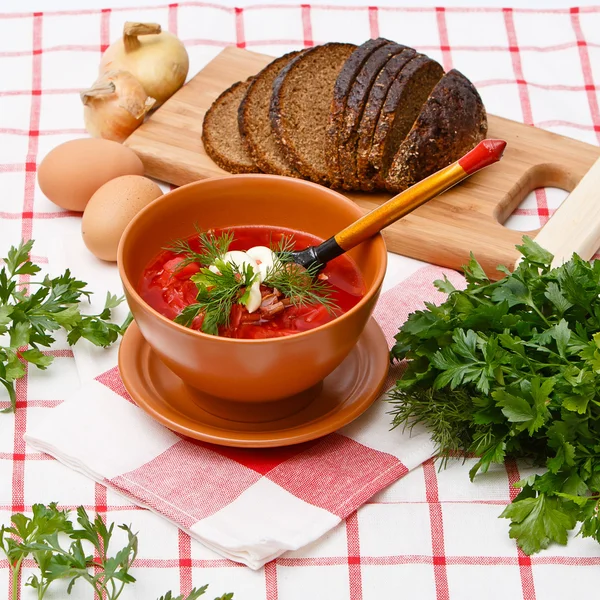 Bowl of homemade red borsch with sour cream and parsley