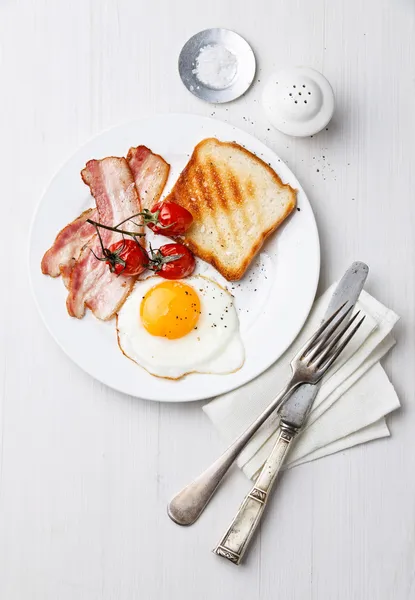 Breakfast with Fried egg and bacon on plate